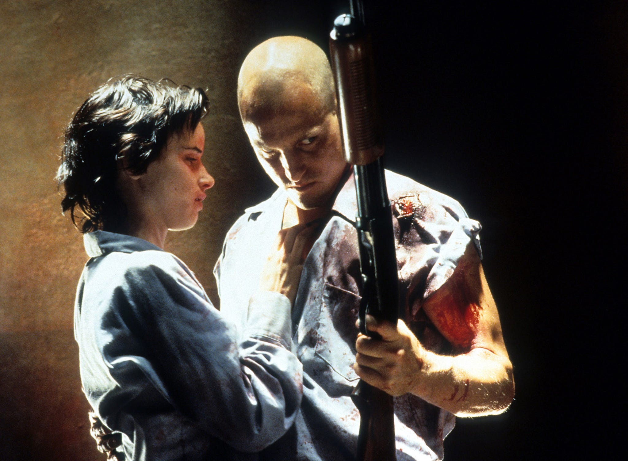 juliette lewis stands with woody harrelson who holds a gun in a scene from the film 'natural born killers', 1994 photo by warner brothersgetty images