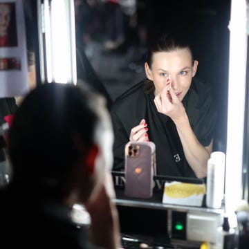 berlin, germany july 03 a model gets her makeup done ahead of the collectivefour danny reinke show during berlin fashion week ss25 at uber eats music hall on july 03, 2024 in berlin, germany photo by joern pollexgetty images