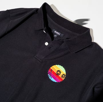 a black shirt with a colorful pin on it