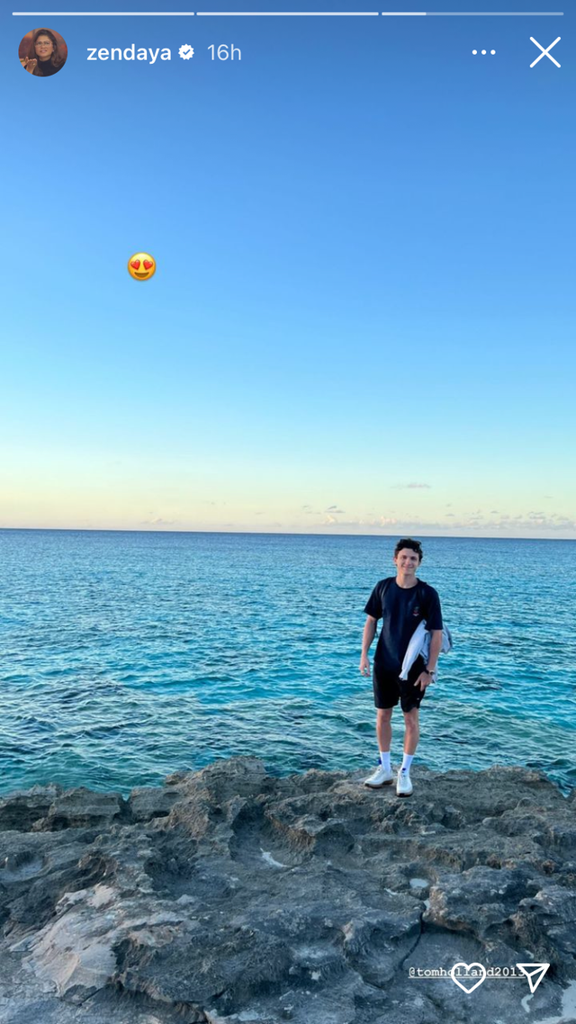 a man standing on a rock with a ball in the air