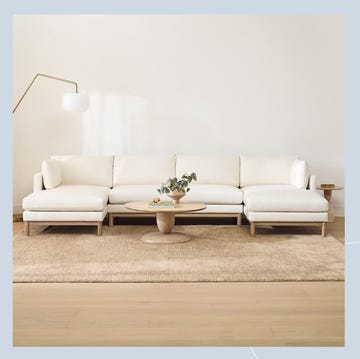 a living room with a white couch and a coffee table