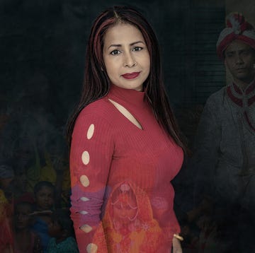 aklima bibi a woman who helps rescue women and girls from forced marriages poses in a red top and she has red streaks in her hair