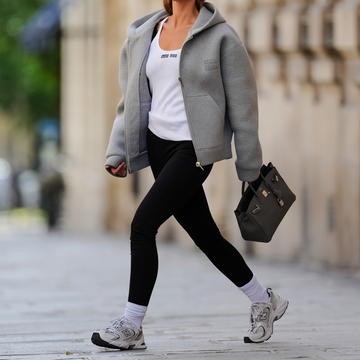 a woman walking with headphones on