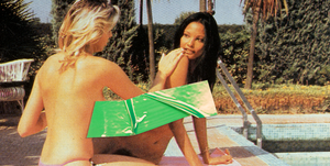 two women sitting on a towel