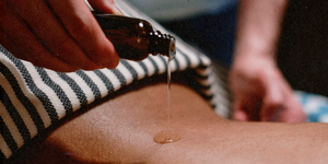 a close up of a person massaging with oil