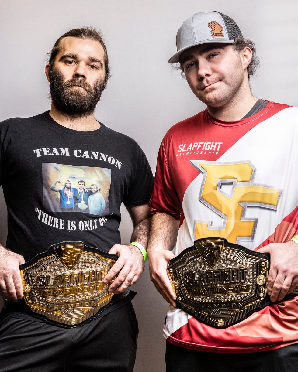 a couple of men holding trophies