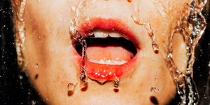 closeup of water rushing down woman's face