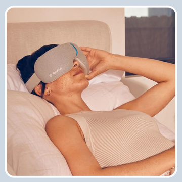 a woman relaxing with a smart sleep mask and a theragun device