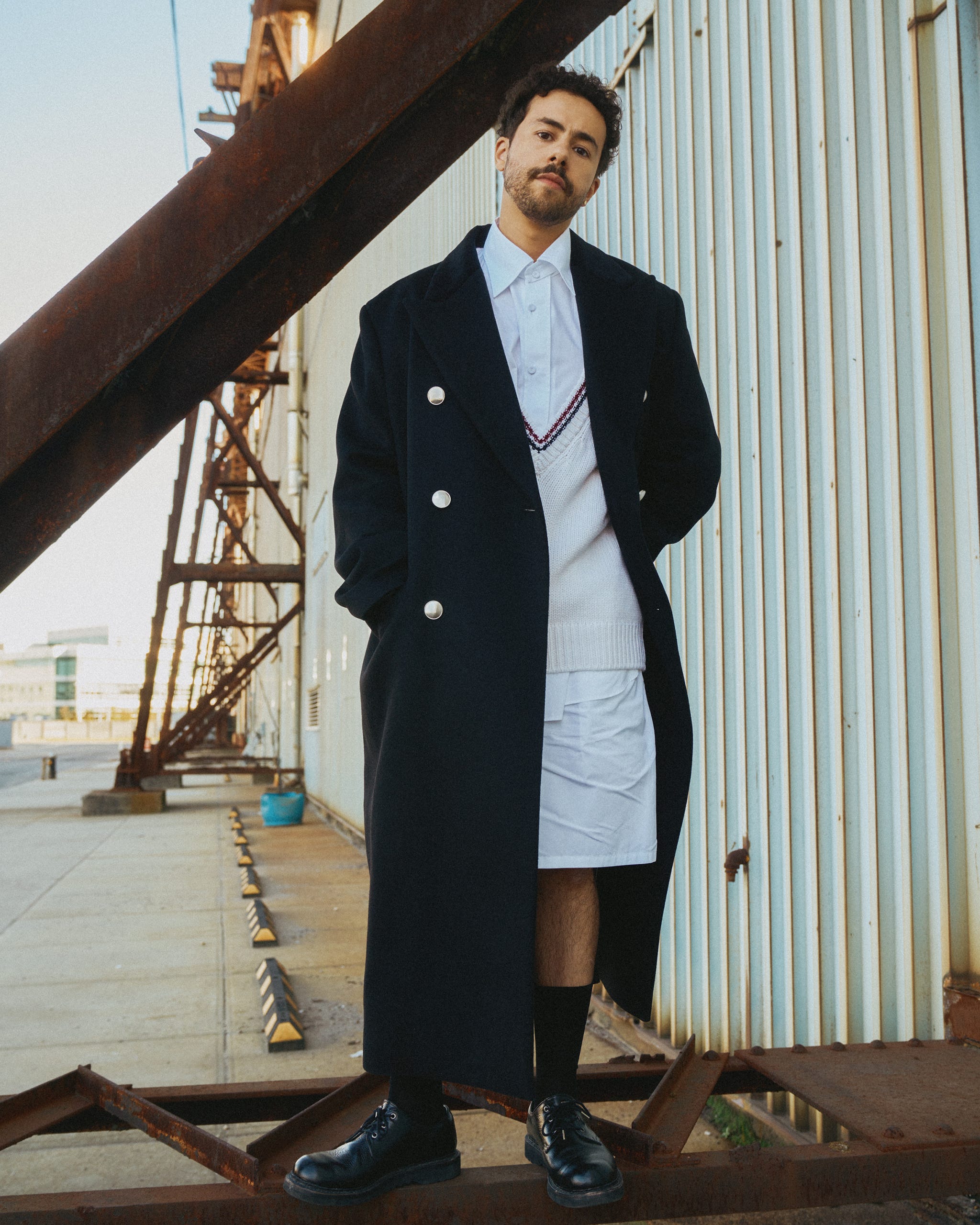 a man in a suit standing on a roof