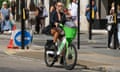 A woman riding a Lime electric hire bike