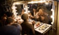 Ensemble cast members apply their make-up in 'the bunker' mid-show