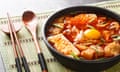 A modern sundubu jjigae – made with gochugaru. Traditionally, the dish is served white. 