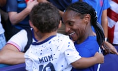 Crystal Dunn holds her son, Marcel, after winning gold with the USA side at the Paris Olympics this summer