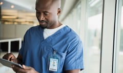 Surgeon using digital tablet at window