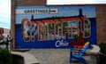 A mural painted on a brick building says 'Greetings from Springfield, Ohio'