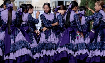 A group of girls in matching purple outfits