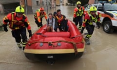 Firefighters use a dingy boat to evacuate civilians after flooding in Faenza, in the region of Emilia Romagna, Italy. 