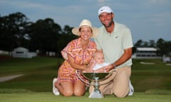 Scottie Scheffler of the United States celebrates with his wife Meredith, son Bennett and the FedExCup trophy after winning the FedExCup and the Tour Championship at East Lake Golf Club on Sunday.