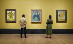 People view, (left-right) Sunflowers,1888, La Berceuse (The Lullaby), 1889 and Sunflowers, 1889 on display during the preview for the National Gallery's Van Gogh: Poets and Lovers exhibition at the National Gallery, London.