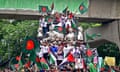 Demonstrators wave Bangladesh's national flag during Martyr March to mark one month since the ousting of the country's former Prime Minister Sheikh Hasina