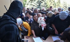 Russian evacuees line up to fill out forms at a humanitarian aid distribution centre in Kursk, Russia. 