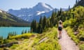 A young woman hiking through Glacier National Park in Montana on a beautiful summer day.