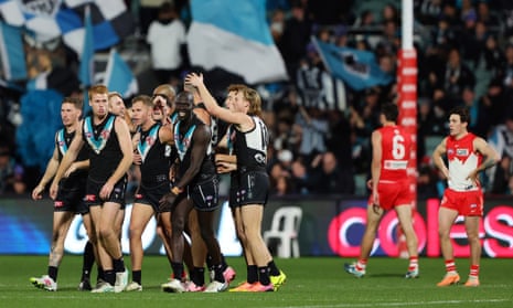 Port Adelaide players celebrate another goal during the round 21 match against the Sydney Swans.