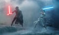 two people battle with red and blue lightsabers