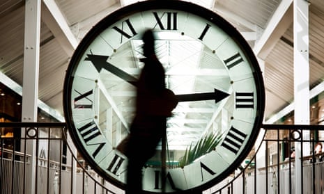 person walking in front of giant clock in dijon, france