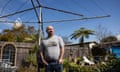 Guy Moore standing under a clothes line in a suburban backyard