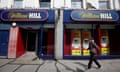 A pedestrian walks past a William Hill betting shop in London, Britain July 25, 2016. REUTERS/Neil Hall