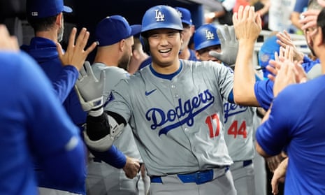 The Dodgers' Shohei Ohtani (17) celebrates after hitting a home run during the sixth inning of Thursday’s game against the Miami Marlins.