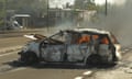 a car burns on a street