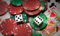 Red and green poker chips, two dice and a king of hearts playing card