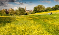 Dog walkers enjoy the view as the storm clouds start rolling in over the water meadow in Malmesbury, Wiltshire.