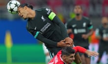 AC Milan's Alvaro Morata, bottom, and  Liverpool's Virgil van Dijk battle for the ball  during the Champions League game between AC Milan and Liverpool at the San Siro stadium in Milan, Italy, Tuesday, Sept. 17, 2024. (Spada/LaPresse via AP)