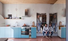 Riccardo (sitting), Katie and Lupa behind him in their kitchen doorway.