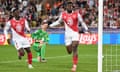 George Ilenikhena celebrates scoring Monaco’s winner against Barcelona, watched by his teammate Folarin Balogun