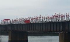 Protesters dressed in white overalls block the coal line that connects the coal mines in the Hunter Valley with the port at Sandgate in Newcastle, May 8, 2016.