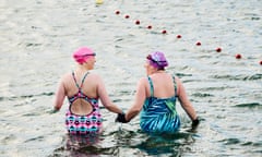 Model release. Female open water swimmers in the sea in winter