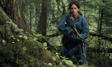 film still of a woman in the woods with a crossbow