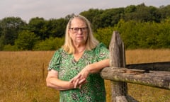 Liz Haigh-Reeve, leaning on a fence post with a field behind her in Kent.