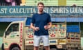 Freddie Flintoff standing in front of a brightly painted lorry on Kolkata.