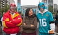 She stands with two men in colourful masks and jerseys, smiling, one with fried chicken