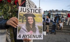 A person holds up a sign saying Justice for Aysenur