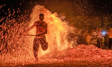 A person runs over burning charcoal