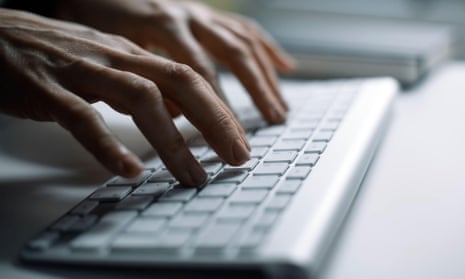 Hands typing on the keyboard in the office.