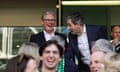 Keir Starmer and Simon Harris laugh while standing behind people in a stadium