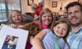 Lauren and Harrison Smith with their daughters and a picture of Benaiah, the Chinese boy they were in the processing of adopting before Beijing announced on 4 September that it was no longer allowing inter country adoptions.