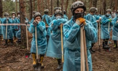 Workers at a mass grave in a forest on the outskirts of Izium